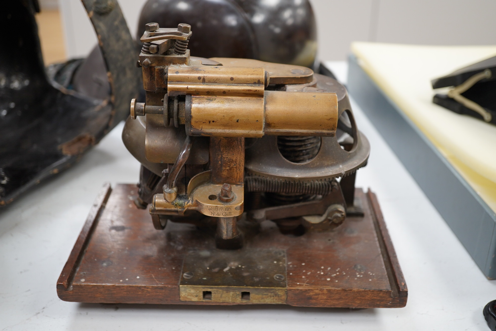 A First World War torpedo gyroscope, stamped 2878 W&Co. top part of the wooden case missing, 21cm high x 24cm wide. Condition - some general wear and damage, unknown if in working order.